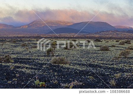 Panoramic image over barren volcanic Timanfaya National Park on Lanzarote with low hanging clouds 108386688