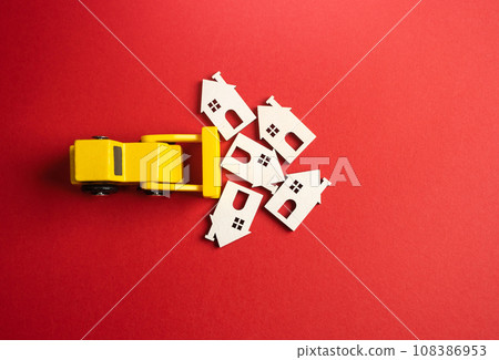 Yellow bulldozer demolishes houses. Pave the way for fresh perspectives. Potential for creative renewal. Clear the area for city development. Preservation and renewal. 108386953