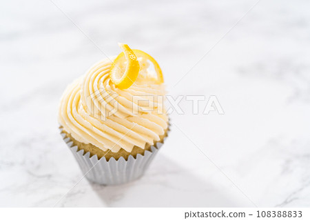 Lemon cupcakes with lemon buttercream frosting, and decorated with lemon swist. Lemon cupcakes with lemon buttercream frosting, and decorated with lemon swist. 108388833