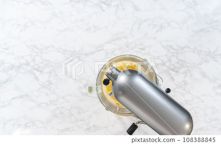 Mixing ingredients in kitchen mixer to bake mini Easter bread kulich. Mixing ingredients in kitchen mixer to bake mini Easter bread kulich. 108388845