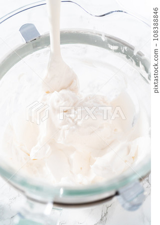 Mixing food coloring into the meringue to bake meringue cookies. Mixing food coloring into the meringue to bake meringue cookies. 108388846