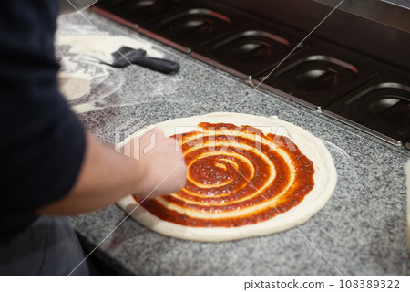 Hands prepairing real italian home made pizza in Lithuania 108389322