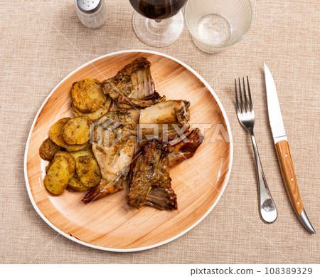 Baked rabbit with potatoes 108389329