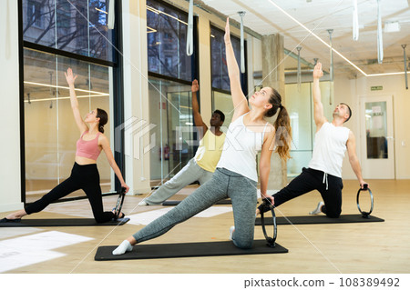 Sporty people doing pilates exercises with Magic Circles 108389492