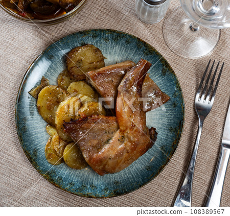 Baked rabbit with potatoes 108389567