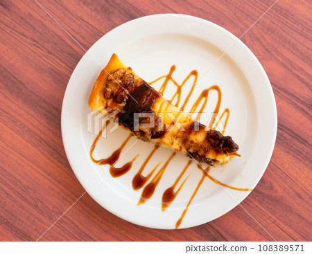Piece of pie with walnuts served in a plate Piece of pie with walnuts served in a plate 108389571