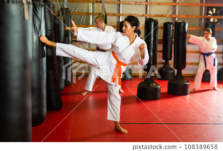 Asian Woman is practicing different kicks Asian Woman is practicing different kicks 108389658