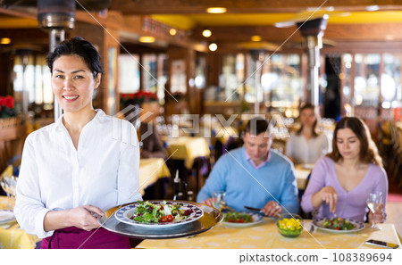 Portrait of asian waitress standing in restaurant Portrait of asian waitress standing in restaurant 108389694