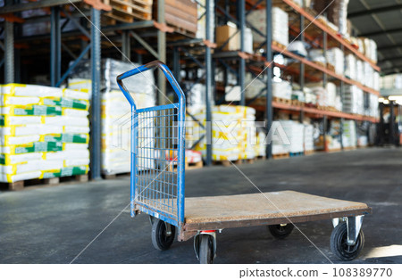 Empty platform hand truck standing in warehouse of hypermarket Empty platform hand truck standing in warehouse of hypermarket 108389770