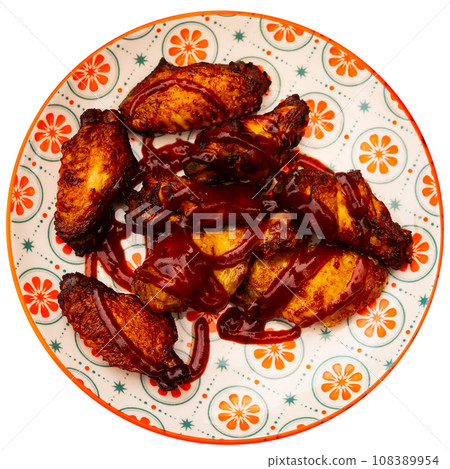 Delicious fried chicken wings with golden crust in sauce bbq on plate. Spanish appetizer - alitas en salsa BBQ 108389954