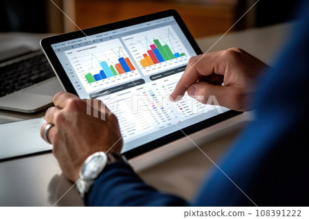 Close-up hand of Businessperson uses a tablet for analysis of business data Close-up hand of Businessperson uses a tablet for analysis of business data 108391222