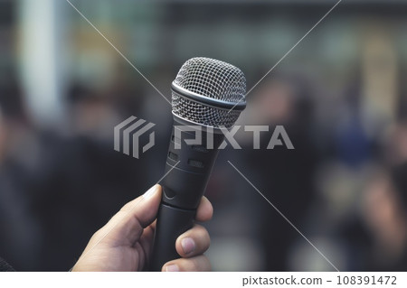 Professional Media interview hand a hold microphone after a press conference Professional Media interview hand a hold microphone after a press conference 108391472