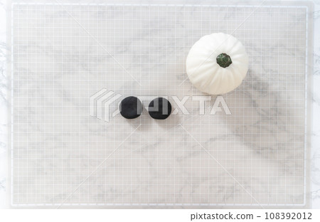 Flat lay. Making ears from black clay to make panda pumpkin for Halloween. Flat lay. Making ears from black clay to make panda pumpkin for Halloween. 108392012