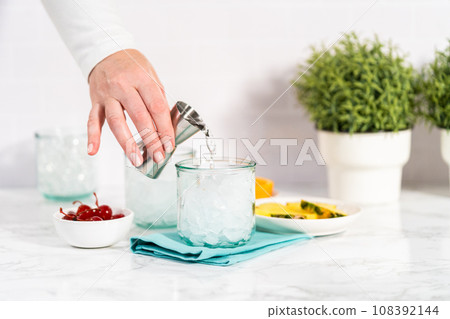 Step by step. Mixing Sunset cocktail with fresh ingredients. Step by step. Mixing Sunset cocktail with fresh ingredients. 108392144