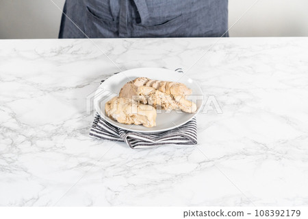 Shredded chicken in a pressure cooker. Freshly cooked chicken breasts on a white plate. Shredded chicken in a pressure cooker. Freshly cooked chicken breasts on a white plate. 108392179