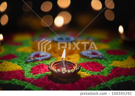 Clay diya lamps lit during diwali celebration, Diwali, or Deepavali, is India's biggest and most important holiday. Clay diya lamps lit during diwali celebration, Diwali, or Deepavali, is India's biggest and most important holiday. 108393291