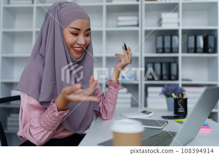 Muslim female employee Conferencing via computer during work Muslim female employee Conferencing via computer during work 108394914