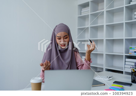 Muslim female employee Conferencing via computer during work Muslim female employee Conferencing via computer during work 108394923