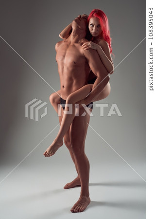 Confident naked woman climbed on man's back like a hunter Confident naked woman climbed on man's back like a hunter 108395043