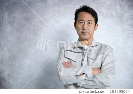 Middle-aged man in work clothes, upper body close-up, arms crossed, looking at camera Middle-aged man in work clothes, upper body close-up, arms crossed, looking at camera 108395094