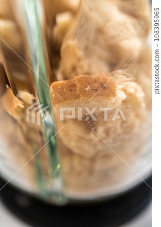 Blending stale bread in a blender to make bread crumbs. Blending stale bread in a blender to make bread crumbs. 108395965