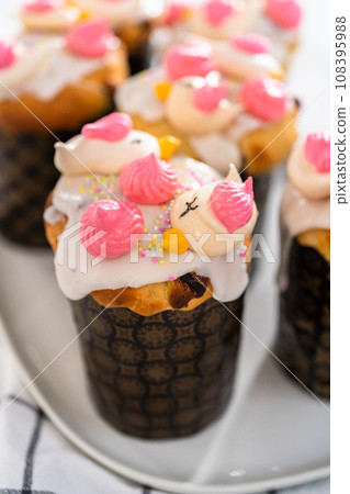 Freshly baked mini Easter bread kulich with lemon glaze, decorated with sprinkles and meringue bird-shaped cookies. Freshly baked mini Easter bread kulich with lemon glaze, decorated with sprinkles and meringue bird-shaped cookies. 108395988