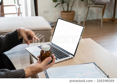 Senior stay at home and use laptop to make online video calls with online doctor to discuss medication Senior stay at home and use laptop to make online video calls with online doctor to discuss medication 108396089