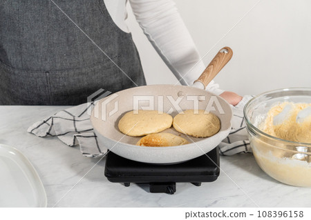 Preparing eggnog pancakes in a nonstick frying pan. Preparing eggnog pancakes in a nonstick frying pan. 108396158