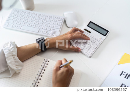businesswoman accountant using calculator for checking financial data saving in office room businesswoman accountant using calculator for checking financial data saving in office room 108396267