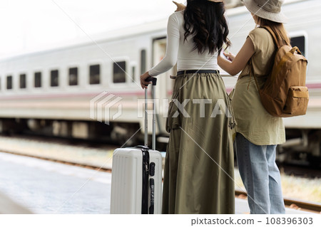 Woman traveler tourist walking with luggage at train station. Active and travel lifestyle concept 108396303