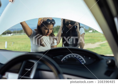 woman car engine problem on road trip or outdoor holiday travel journey 108396485