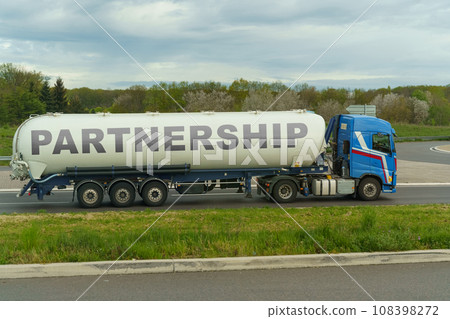 On a tank truck driving along the road there is an inscription - PARTNERSHIP 108398272