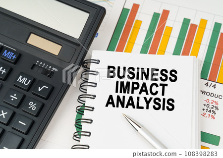 On business charts there is a calculator, a pen and a notepad with the inscription - BUSINESS IMPACT ANALYSIS 108398283