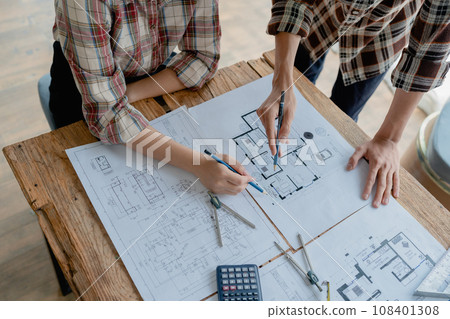 multi ethnic engineer brainstorming and measuring for cost estimating on blueprint and floor plan drawings about design architectural and engineering for houses and buildings. multi ethnic engineer brainstorming and measuring for cost estimating on blueprint and floor plan drawings about design architectural and engineering for houses and buildings. 108401308