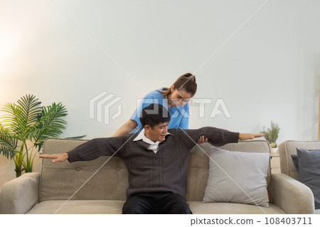 Asian female doctor advice elderly patient to physiotherapist to exercise at home 108403711