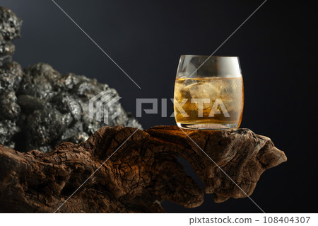 Old fashioned rum cocktail with ice and dried orange. Old fashioned rum cocktail with ice and dried orange. 108404307