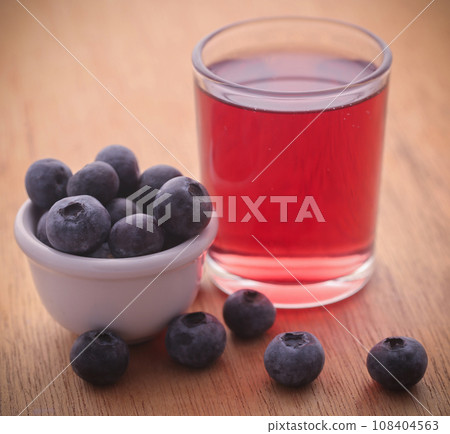 Group of fresh blueberries with juice 108404563