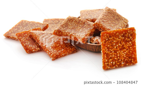 Sesame caramel candy 108404847