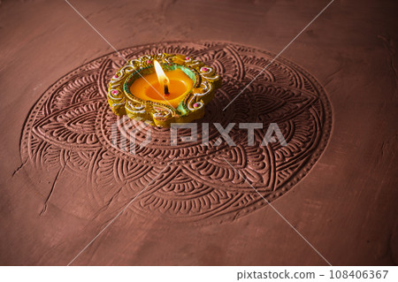 Burning diya on Happy Diwali, background for light festival of India Burning diya on Happy Diwali, background for light festival of India 108406367