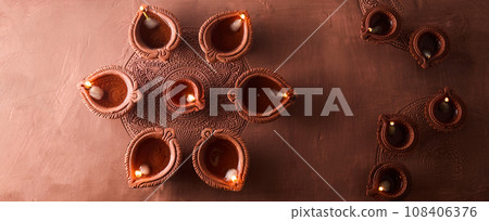 Burning diya on Happy Diwali, background for light festival of India Burning diya on Happy Diwali, background for light festival of India 108406376