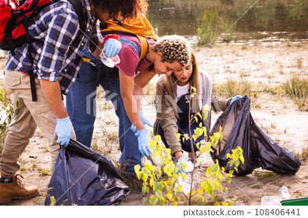 Eco Warriors: Multiracial Millennials Clean Up Forest Lake Shore 108406441