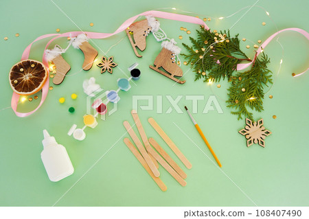 Step by step instruction how to make christmas toys from ice cream sticks. Step 1 1 preparation tools paints, brush and wood sticks for children New year craft. Children's New year handmade craft 108407490