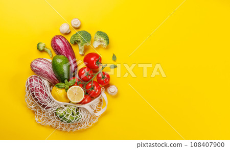 Mesh bag filled with a variety of vegetables 108407900