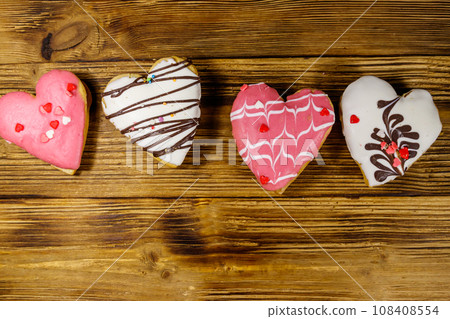 Heart shaped cookies on wooden table. Top view. Dessert for Valentine day Heart shaped cookies on wooden table. Top view. Dessert for Valentine day 108408554