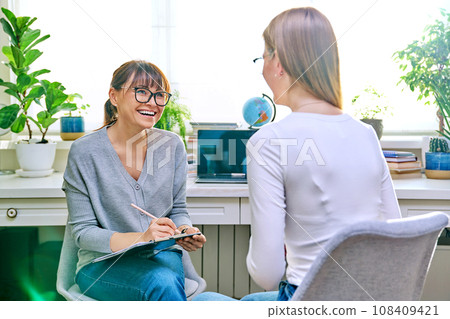 Female psychologist working with young teen girl 108409421
