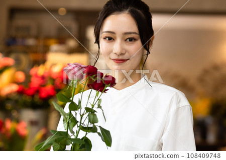Cute woman working in a flower shop Cute woman working in a flower shop 108409748