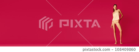 Banner. Girl dressed in underwear and pajama with ponytail hairstyle posing lying on floor and looking at camera. Cheerful woman enjoy morning. Banner. Girl dressed in underwear and pajama with ponytail hairstyle posing lying on floor and looking at camera. Cheerful woman enjoy morning. 108409860