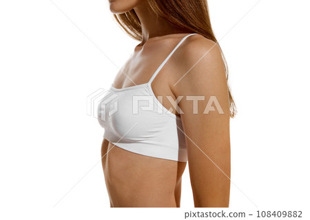 Side view. Cropped perfect naked body shape female body, breast dressed in innerwear against studio background. Concept of dieting. 108409882