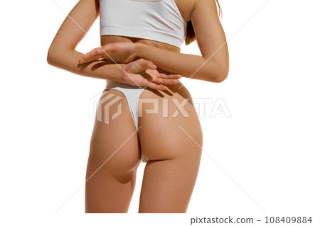 Back view of cropped fit with perfect body shape female body, buttocks in underwear against white studio background. Concept of dieting. Back view of cropped fit with perfect body shape female body, buttocks in underwear against white studio background. Concept of dieting. 108409884