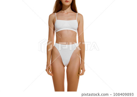 Front view. Cropped perfect naked body shape female body, breast, stomach dressed in underwear against studio background. Concept of dieting. 108409893
